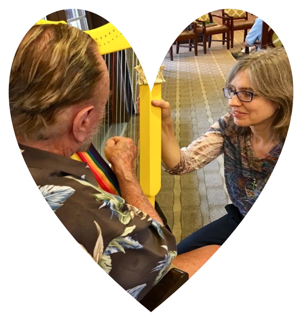 Kirsti Kaldro offering harp therapy to a patient